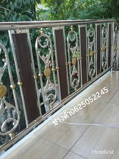 the balcony railing is made of metal and has decorative designs on it's sides