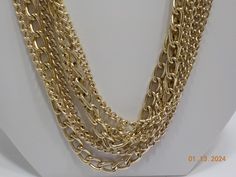 Vintage 52" gold tone chains necklace. Triple strands. Hinged clasp. Excellent vintage condition. Made in Japan. Gold Multi-strand Chain Necklace, Gold Multi-strand Costume Jewelry Necklace, Gold Multi-strand Figaro Chain Necklace, Gold Multi-strand Layered Necklace With Figaro Chain, Gold Multi-strand Chain Necklace For Formal Events, Gold Multi-strand Chain Necklace For Formal Occasions, Gold Multi-strand Necklace With Adjustable Chain, Gold Double Strand Layered Necklace With Chunky Chain, Formal Gold Multi-strand Layered Necklace