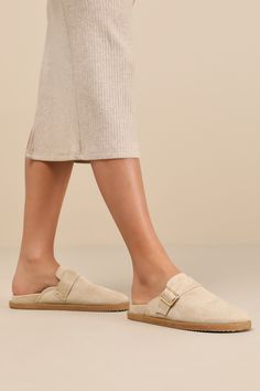 Ideal for effortless days, the Billini Orlin Desert Taupe Suede Buckle Slip-On Clogs always bring a coveted vibe! Soft faux suede leather shapes these must-have flats that have a clog-style silhouette with a rounded toe, an adjustable gold buckle strap, and a notched collar. The simple slide-on design has a .5"" contoured, lined insole that makes for comfy all-day wear! Available in whole sizes only. 0. 5" rubber sole. Lined smooth insole. Rubber sole has nonskid markings. Man made materials. Im Clog Style, Clogs Style, Suede Slides, Notched Collar, Suede Leather, Faux Suede, Clogs, Rubber Sole, Slip On