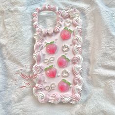 a cell phone case made to look like strawberrys with pearls and jewels on them