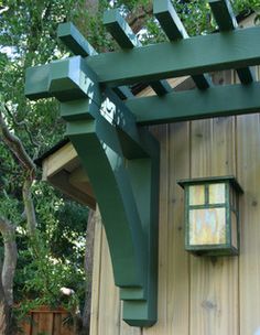 a wooden structure with a lantern hanging from it's side