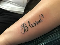 a person with a tattoo on their arm that says, blasedt and cross