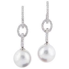 18K White gold drop earrings featuring two South Sea pearls measuring 11-12 mm and 68 round brilliants weighing 0.81 carats. Pearl Quality AAA Luster AAA, Excellent Nacre Very Thick White Gold Drop Earrings, Hoop Dangle Earrings, Golden South Sea Pearls, Vs Diamond, Sea Pearl, South Sea Pearls, Sea Pearls, Diamond Drops, Pearl Diamond