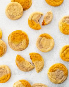 several cookies that have been cut in half and are on a white surface with one bite taken out