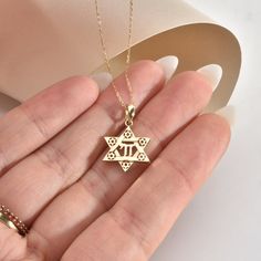 With this stunning 14K Solid Gold Star of David Chai Pendant, you'll shine like a star. This stunning 18K Jewish Identity David Star Necklace is a timeless representation of life and tradition. This pendant is made of exquisite pure gold and includes a delicate six-pointed star carved with detailed embellishments. The Hebrew word "life" is represented by the chai sign in the center, making this a memorable gift for any occasion. Whether you're honoring your faith or reconnecting with your herita 14k Gold Star Of David Jewelry For Anniversary, Gold Star Of David Jewelry For Anniversary, Star Of David Jewelry With Star Charm For Anniversary, 14k Gold Star Of David Necklace Engraved, 14k Gold Star Of David Necklace For Anniversary, Star Of David Charm Jewelry For Anniversary, Jewish Symbol, David Star, Star Of David Necklace