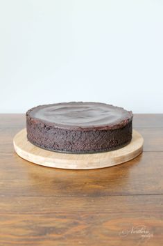 a chocolate cake sitting on top of a wooden plate