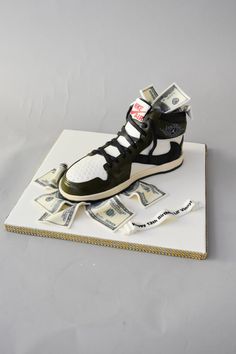 a pair of sneakers sitting on top of money