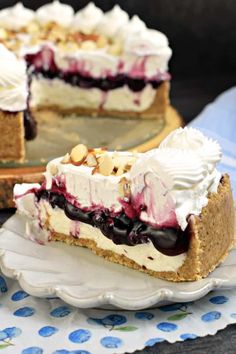 a piece of pie with blueberries and whipped cream on top sitting on a plate