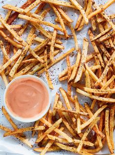 french fries with dipping sauce on top