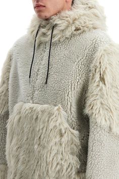 Crafted in wool shearling and faux fur, this Sacai jacket stands out for its hoodie-inspired design, featuring a drawstring hood, two-way zip closure, and divided kangaroo pocket. The loose fit is lined on the inside. The model is 182 cm tall and wears size 2. Composition: 100%WO, 100%PL Hooded Outerwear With Faux Fur Trim And Sheepskin, Hooded Outerwear With Faux Fur Trim In Sheepskin, Hooded Sheepskin Outerwear With Faux Fur Trim, Sheepskin Hooded Outerwear With Faux Fur Trim, Hooded Sheepskin Outerwear With Fleece Lining, Hooded Shearling Outerwear With Faux Fur Lining, Hooded Shearling Outerwear For Winter, Hooded Sheepskin Winter Outerwear, Hooded Shearling Fur Coat With Faux Fur Trim