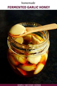 homemade fermented garlic honey in a jar with a wooden spoon