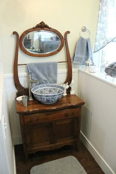 a bathroom with a sink, mirror and towel rack in it's corner next to a bathtub