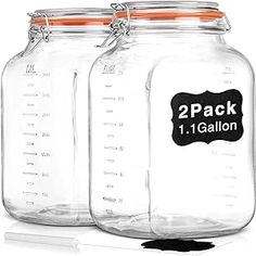 three mason jars with labels on them sitting next to each other