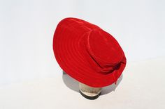 "Vintage Women's Hat Chapeau Asymmetrical Brimmed Red Velvet Mid Century Rockabilly Church Style Bridal Accessory Christmas Hat. There is nothing better than anything red Here's a great example! A beautiful ruby red, velvet hat. The brim is larger in front. Quilting details on the large, wired, front brim and top of the hat. 2 bands of velvet ribbon bows around crown of the hat. No makers markings. It measures approximately 19 1/2\" around inside band. In great condition! Very clean! The crown i Red Retro Party Hat, Retro Red Party Hat, Red Vintage Mini Hats With Curved Brim, Vintage Red Adjustable Mini Hats, Red Adjustable Vintage Mini Hats, Vintage Red Bucket Hat, Kitsch Christmas, Church Fashion, Bridal Accessory