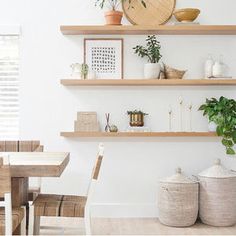 the shelves are filled with potted plants and vases on them, along with other decorative items