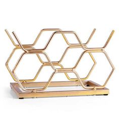 a gold metal shelf with three shelves on each side