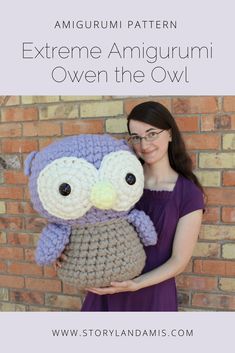 a woman is holding an owl crocheted stuffed animal