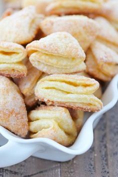 small pastries in a white dish on a wooden table