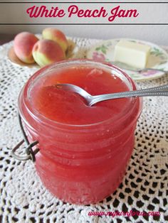 a jar filled with liquid sitting on top of a doily next to some fruit