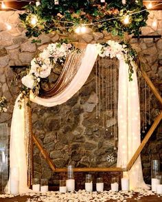 a wedding arch with flowers and candles