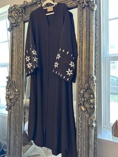 Elegant brown abaya with beautiful floral sleeve embroidery 🤎 Free size fits small medium and large  Legnth 54" Modest Floral Embroidered Abaya For Eid, Eid Long Sleeve Abaya With Floral Embroidery, Eid Abaya With Floral Embroidery And Long Sleeves, Black Thobe With Floral Embroidery And Long Sleeves, Elegant Long Sleeve Thobe With Floral Embroidery, Modest Long Embroidered Kaftan, Black Long Sleeve Thobe With Floral Embroidery, Embroidered Long Sleeve Modest Abaya, Modest Long Sleeve Embroidered Abaya