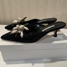 New And Never Worn Manolo Blahnik Mules Wrapped In Black Grosgrain With Sleek Pointed Toe, Leather Lining, And 50mm Kitten Heel. Gorgeous Beads And Pearls Dangling For Embellishment. Size 39.5 - Fits Us 9 To 9.5 Comes With Box And Dust Bags. Elegant Slip-on Heels For Evening, Embellished Almond Toe Heels For Cocktail, Formal Embellished Pointed Toe Heels, Chic Embellished Heels For Formal Occasions, Designer Embellished Closed Toe Heels, Designer Embellished Almond Toe Heels, Chic Embellished Heels, Elegant Embellished Slip-on Heels, Designer Slip-on Heels For Evening