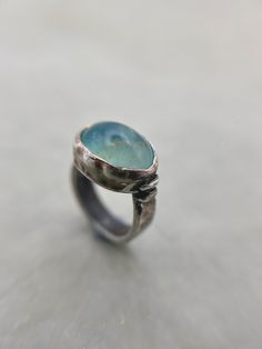 This listing is for a beautiful rare light aqua blue Andean Opal gem stone set into a chunky darkened sterling silver ring with a rustic finish for an earthy look. Opal is found and revered across the globe and can be found all over, from Canada to Ethiopia, Australia to Madagascar. But none are as rare and beautiful as the Andean Opals. These opals could only be found in Andean mountains in Peru.  Materials: Sterling silver 925 and fine silver 999, Andean blue Opal (Peru). Dimensions: Ring size Silver Aquamarine Jewelry With Natural Stones, Spiritual Blue Topaz Jewelry In Blue, Light Blue Aquamarine Birthstone Jewelry, Aquamarine Gemstone Jewelry For Jewelry Making, Unique Oval Birthstone Gemstones, Handmade Blue Topaz Blue Jewelry, Aquamarine Gemstone Jewelry For Anniversary, Ocean-inspired Silver Gemstone Jewelry, Handmade Blue Topaz Jewelry