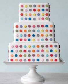 a white cake with multi colored polka dots on it