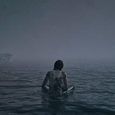 a person sitting on a surfboard in the water