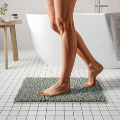 a woman's bare legs are shown in front of a bathtub