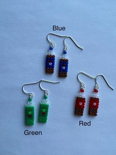 three lego style earrings with different colors and shapes, one is red, the other is blue