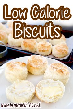 biscuits and butter on a plate next to a baking pan with other baked goods in the background