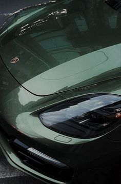 a green sports car parked on the street