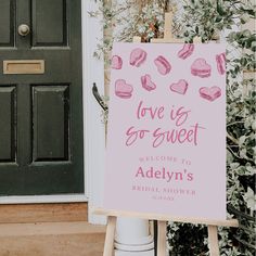 a pink sign that says love is sweet welcome to adelin's bridal shower