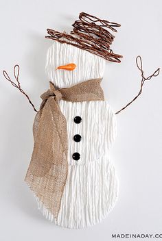 a snowman made out of yarn and twigs