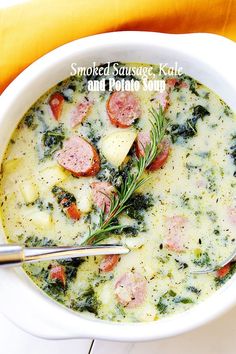 a bowl of soup with sausage, kale and potato soup on a yellow napkin