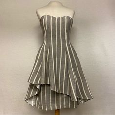 Strapless Striped Mini Dress.Dress Is Fitted With Asymmetrical Flare Layer Over The Bottom Half. Color: Gray Size: Xsmall(6) Small(9) Medium (5) Large(Shop Secondchancepg.Com For An Additional 10% Off. Use Discount Code Pm10 Spring Strapless Fitted Dress With Asymmetrical Hem, Fitted Strapless Dress With Asymmetrical Hem For Spring, Fitted High Low Summer Cocktail Dress, Fitted Strapless Dress With Asymmetrical Hem For Summer, Fitted High Low Dress For Spring Cocktail, Fitted High Low Cocktail Dress For Spring, Fitted Strapless Dress With Asymmetrical Hem For Cocktail, Fitted Strapless Asymmetrical Dress For Date Night, Mm Couture Dress