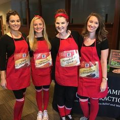 three women in red aprons standing next to each other