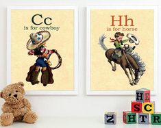 two children's posters on the wall above a teddy bear and wooden block letters