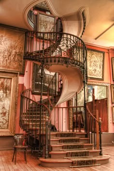 a spiral staircase in an ornately decorated room