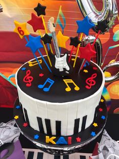 a birthday cake decorated with musical instruments and stars