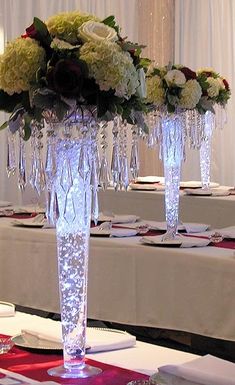 the centerpieces are adorned with crystal candlesticks and flowers in clear vases