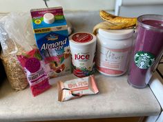 the contents of a starbucks coffee drink sitting on top of a counter next to some snacks