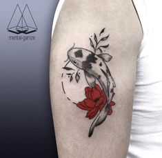 a woman's arm with a koi fish and flower tattoo design on it