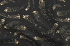 gold stars and swirls on black fabric