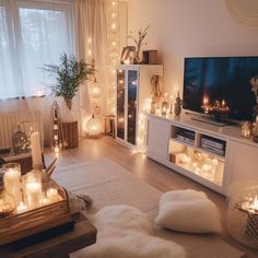 a living room filled with lots of candles and lights on the wall behind a flat screen tv