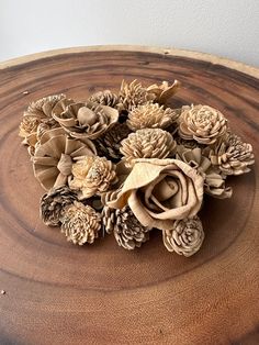 a wooden table topped with lots of fake flowers