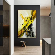 an abstract painting hangs on the wall next to a bench in a modern living room