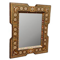 an ornately decorated mirror is shown against a white background