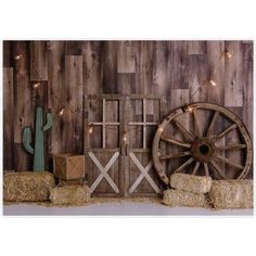 an old wooden wall with hay bales and a cactus